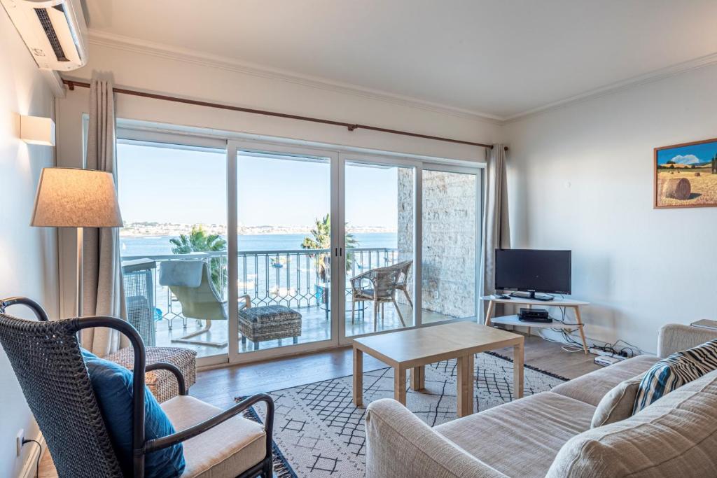 a living room with a couch and a table at Cascais Bay Terrace ii in Cascais