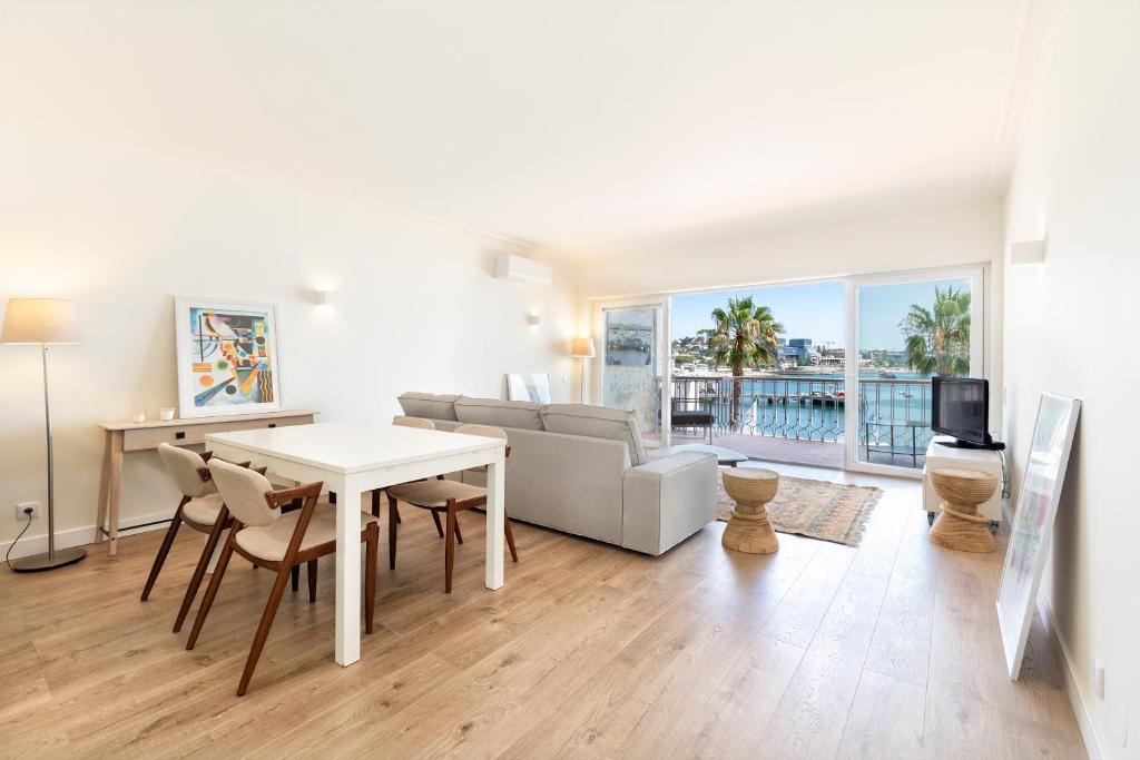 a living room with a table and a couch at Cascais Bay Terrace iii in Cascais