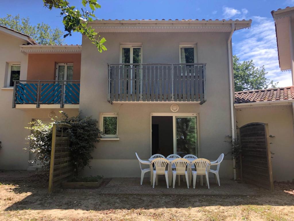 a table and chairs in front of a house at House near the ocean and forest in Soulac-sur-Mer