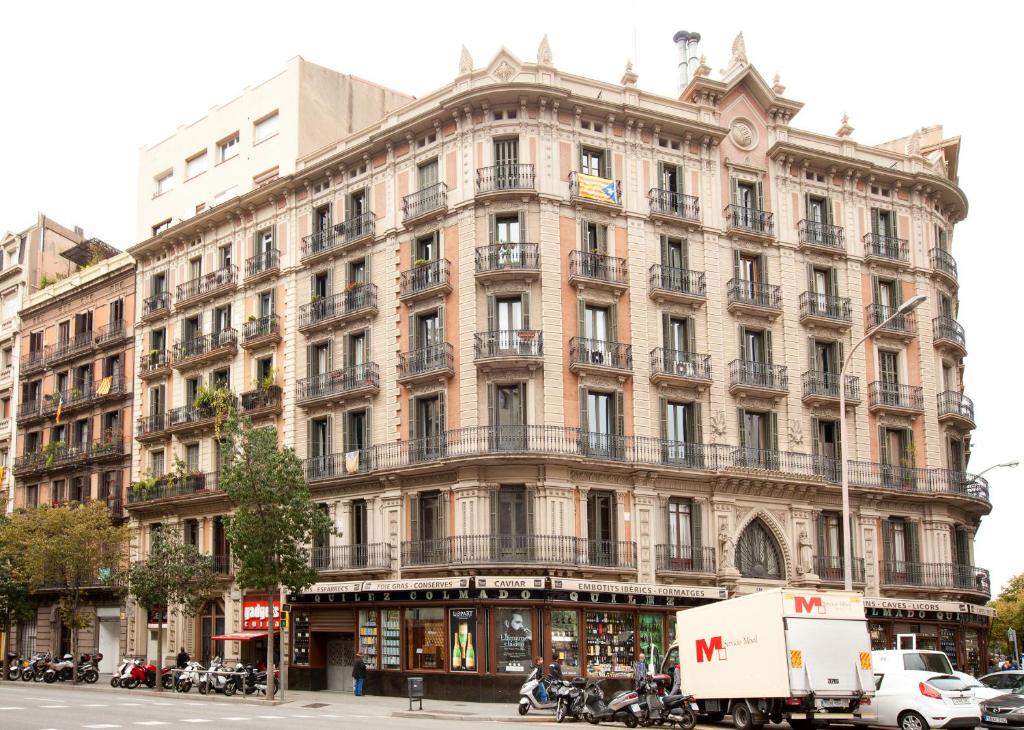 a large building on the corner of a street at Barnapartments Rambla Cataluña in Barcelona