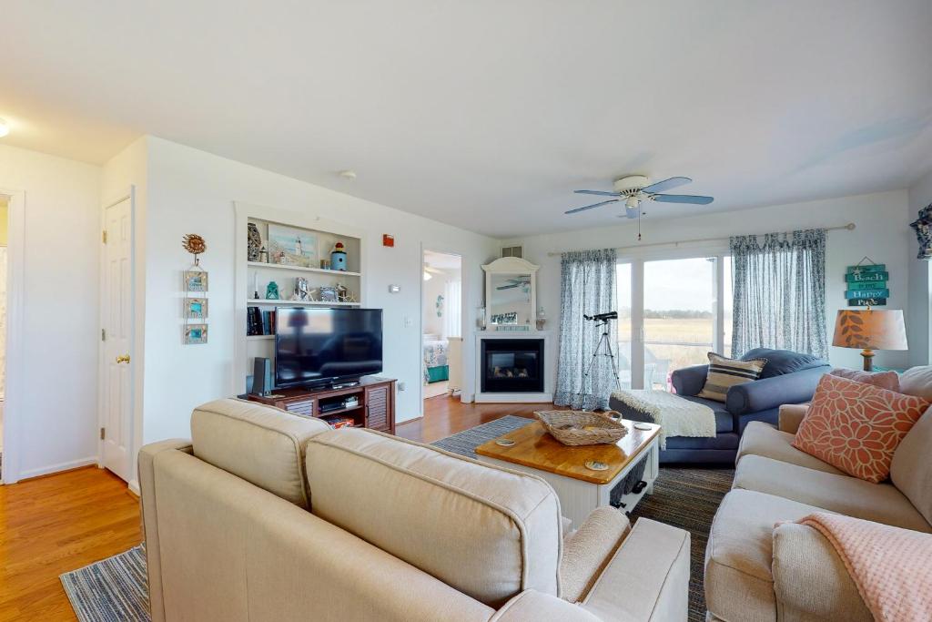 a living room with two couches and a tv at Bethany Bay -- 37185 Harbor #3602 in Ocean View