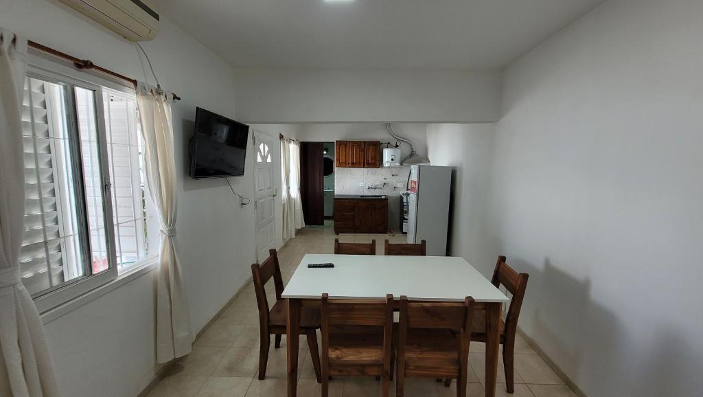 a kitchen and dining room with a table and chairs at Departamento Don Nico in San José de la Dormida