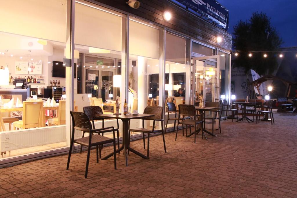 a group of tables and chairs in front of a store at Hotel Galion in Gdańsk