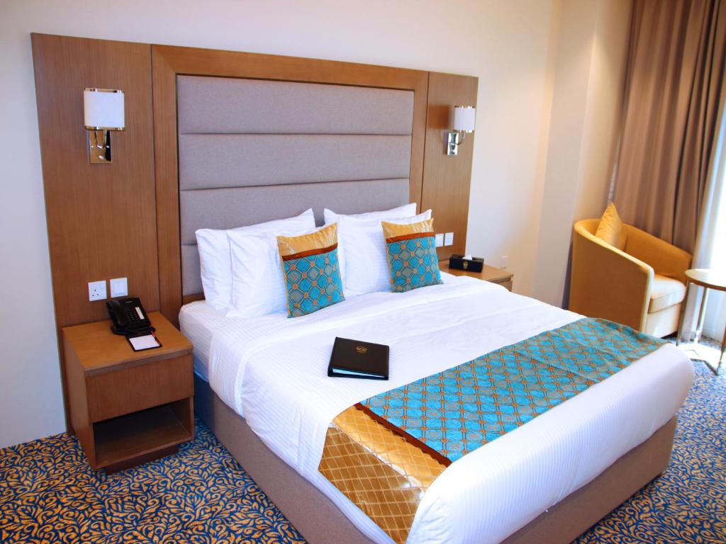 Postel nebo postele na pokoji v ubytování ROZANA HOTEL