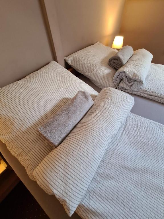 A bed or beds in a room at Palantír Panzió