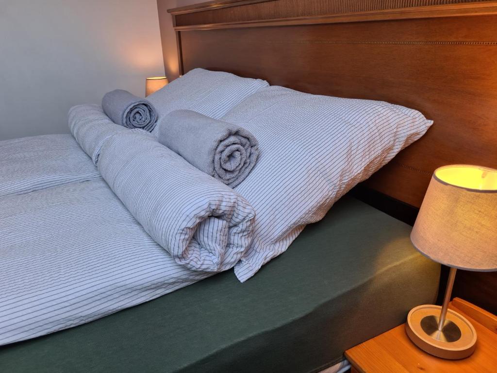 A bed or beds in a room at Palantír Panzió