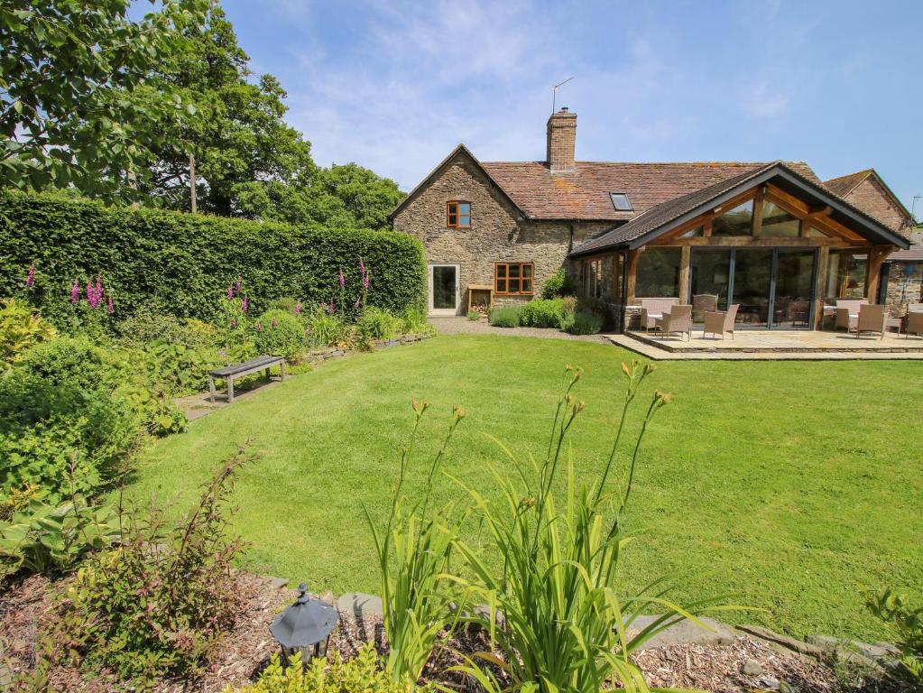 an external view of a house with a garden at The Old Farmhouse in Craven Arms