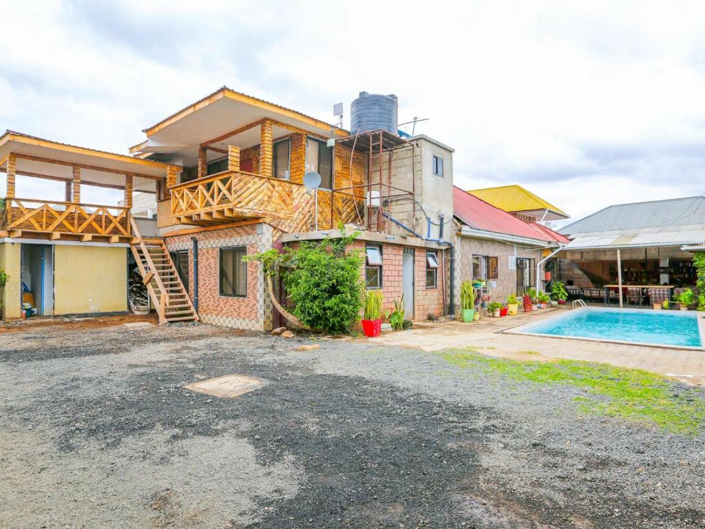 an image of a house with a swimming pool at Arusha Safari Hostel in Arusha
