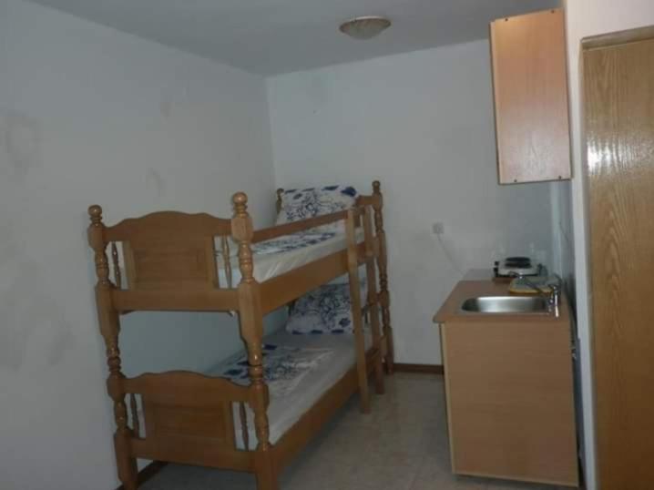a room with a bunk bed and a sink at Bojana Blue Retreat in Ulcinj