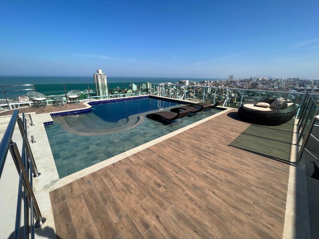 a swimming pool on the roof of a building at Golden Towers Hotel in Macaé