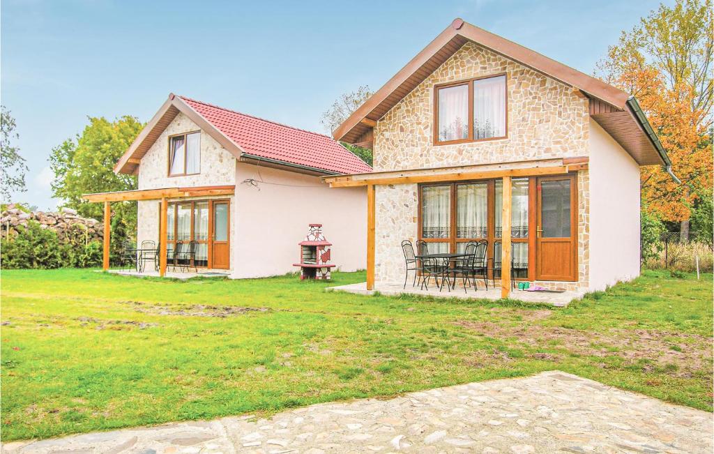 a house with a lawn in front of it at Awesome Home In Swinoujscie With 2 Bedrooms, Wifi And Outdoor Swimming Pool in Świnoujście