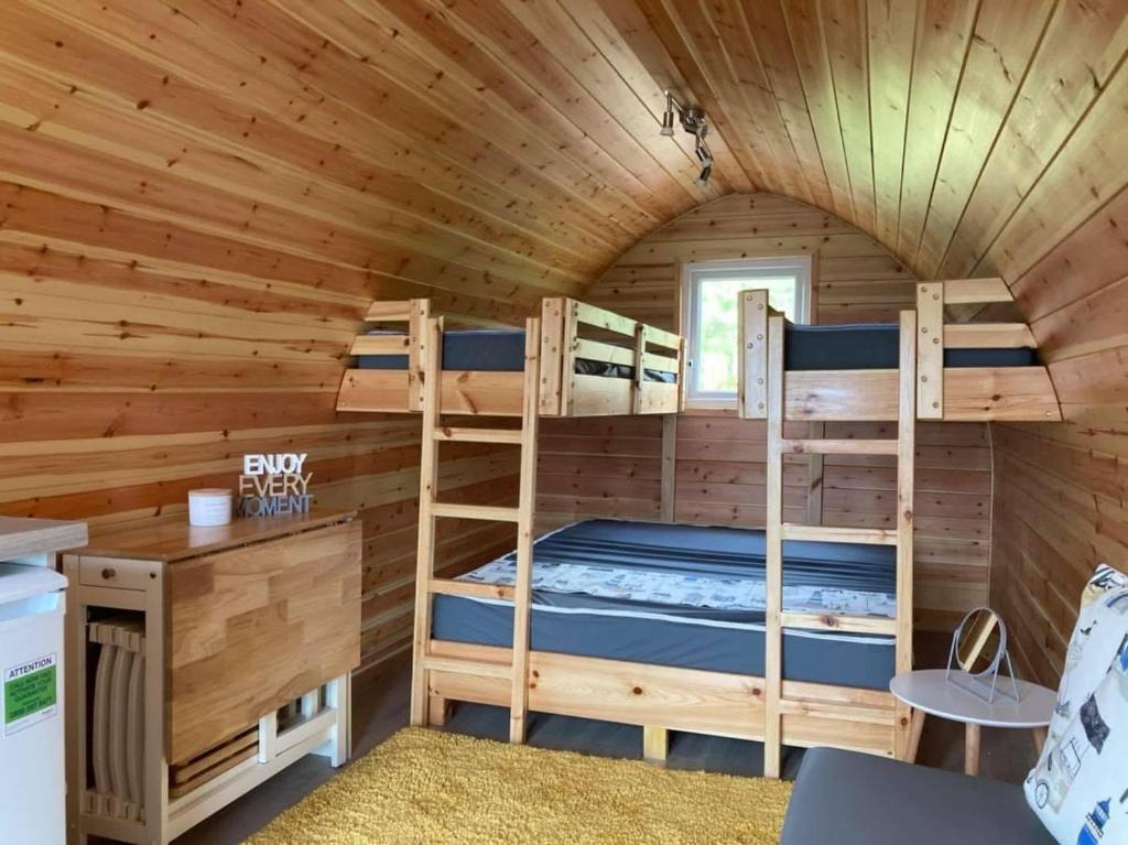 a room with bunk beds in a log cabin at Marina Bay Pods in Aberdeen