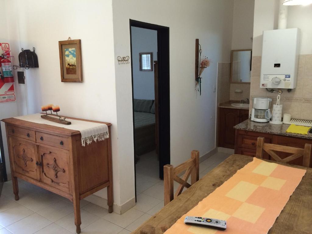 a kitchen and dining room with a table and a counter at Country House Trabun Curev in Capilla del Monte