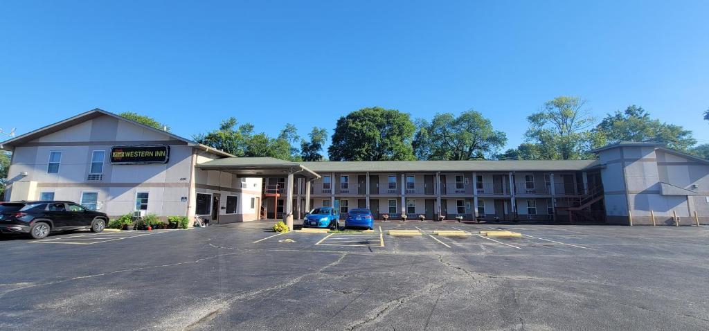 a hotel with a parking lot in front of it at FIRST WESTERN INN in Caseyville