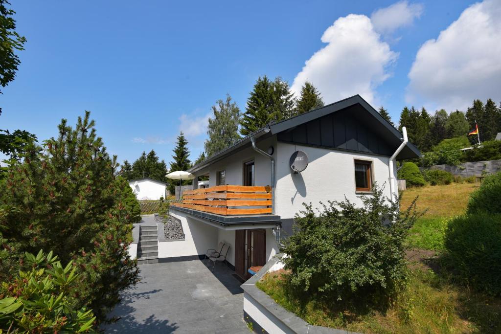 a white house with a black roof at Bungalow im Thüringer Wald/ Haus Selma in Suhl