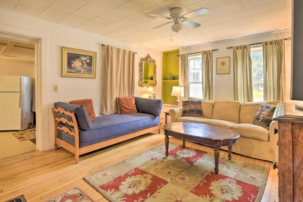 a living room with a couch and a table at Pet-Friendly Roxbury Farmhouse on 350 Acres! in Roxbury
