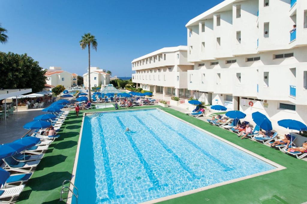 a swimming pool in front of a hotel at Kissos Hotel in Paphos