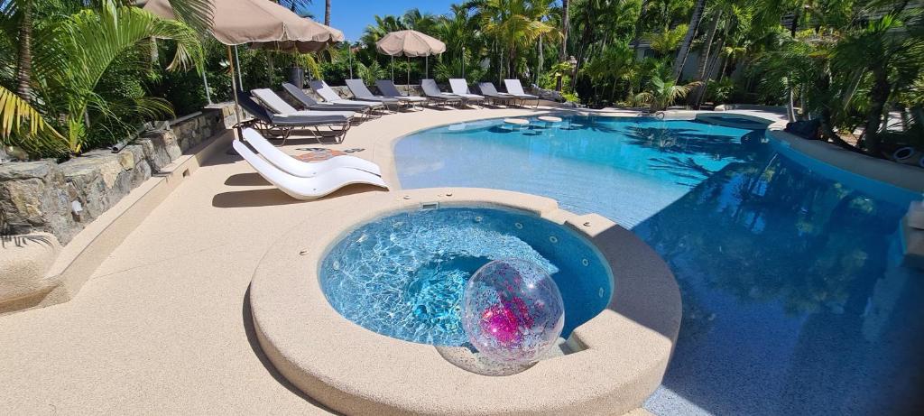 a swimming pool with a mermaid ball in the water at Résidence Adam et Eve in Orient Bay