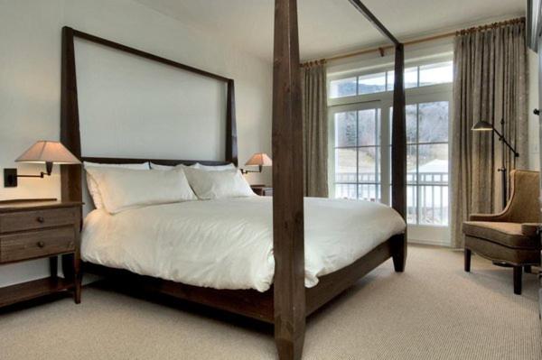 a bedroom with a large bed and a large window at Clay Brook Hotel at Sugarbush in Warren