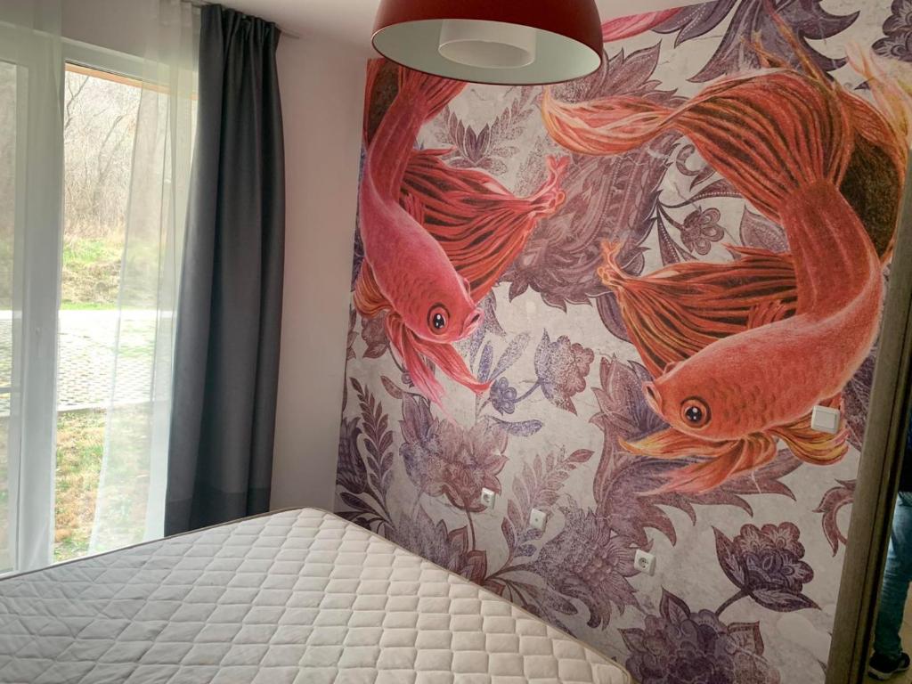 a bedroom with a bed with a painting of fish at Свети Йоан in Sozopol