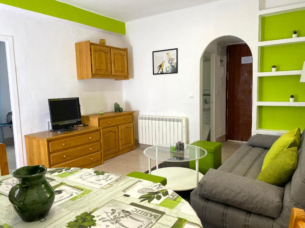 a living room with a couch and a table at Casa el Tejar - Apartamento céntrico y acogedor in Arcos de Jalón