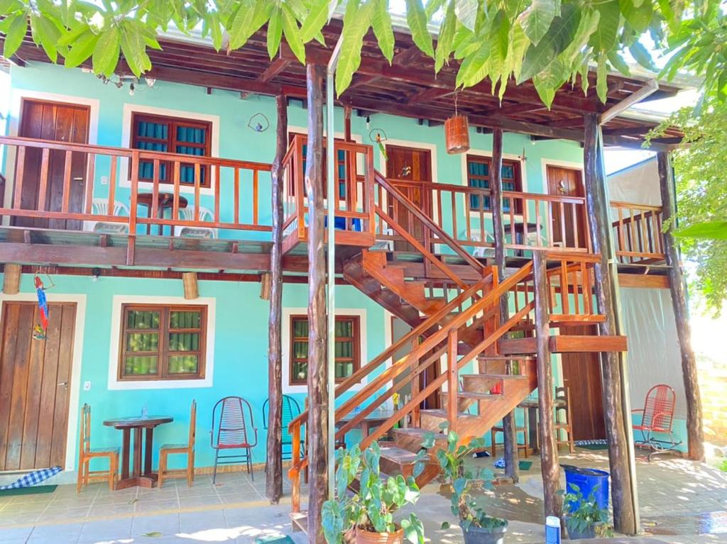 a house with a wooden staircase in front of it at Pousada Nenzinha in Sao Jorge