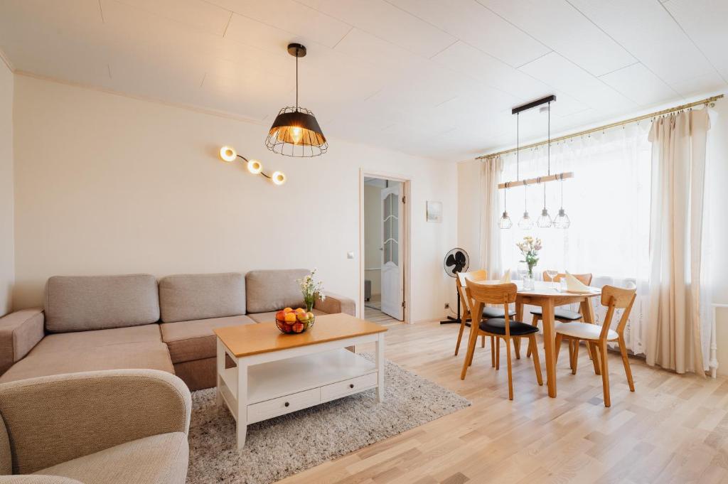a living room with a couch and a table at Kuuse 4 Apartment with 2 bedrooms in Haapsalu