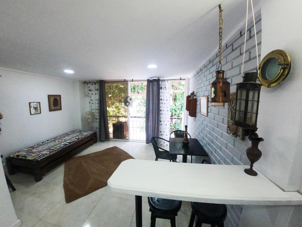 a living room with a white table and a couch at Sunset View, Taganga in Taganga