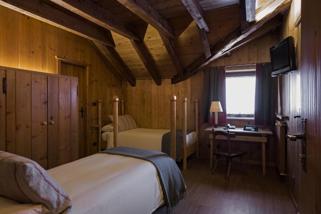 Postel nebo postele na pokoji v ubytování Albergo Ristorante Bucaneve
