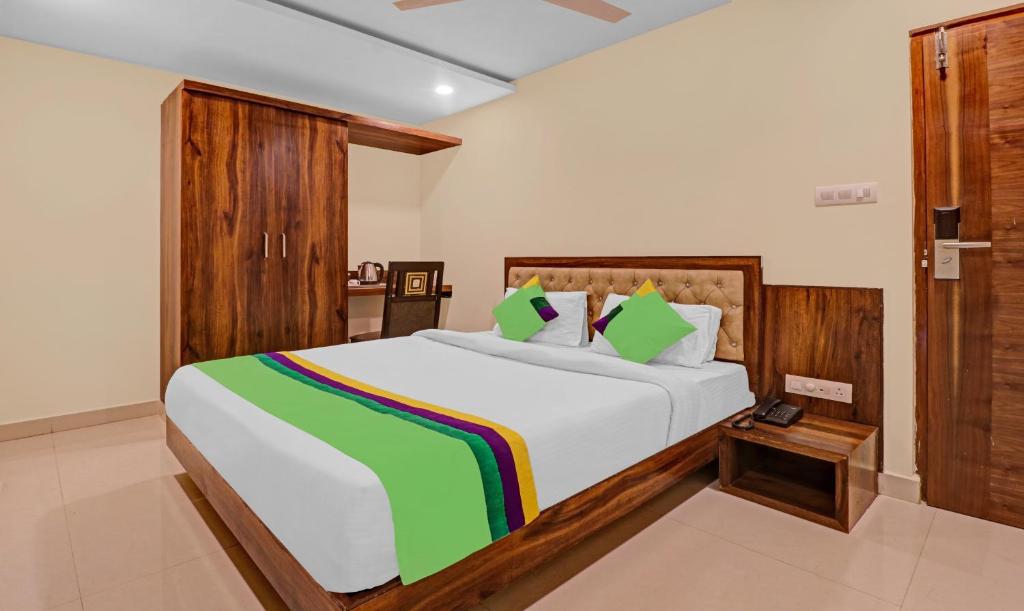 a bedroom with a large bed with a colorful blanket at Treebo Trend Krishnam Boutique in Bangalore