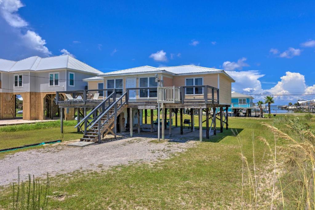 a house on a dock on the beach at Lovely Dauphin Island Cottage with Deck and Gulf Views in Dauphin Island