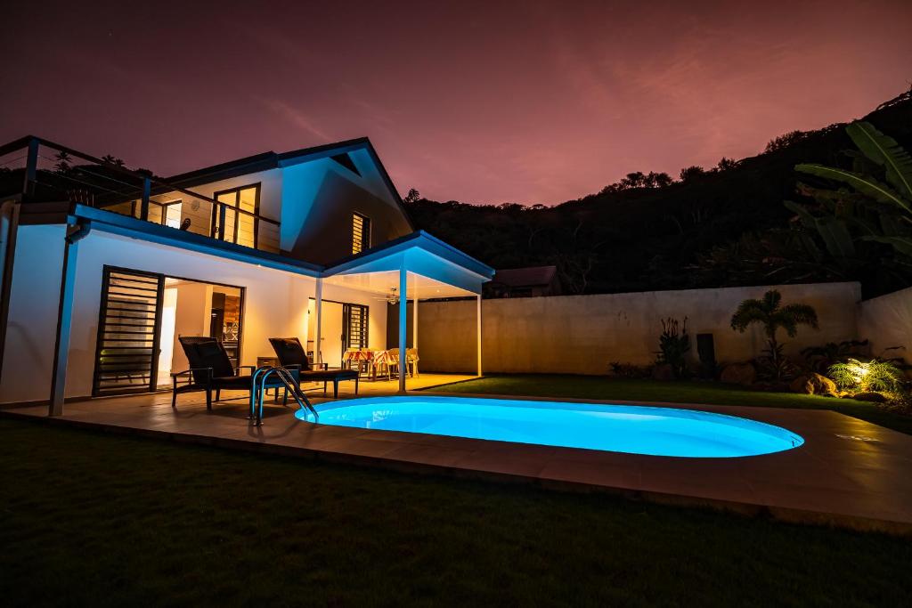 a villa with a swimming pool at night at Hidden Mo'a Villa in Bora Bora