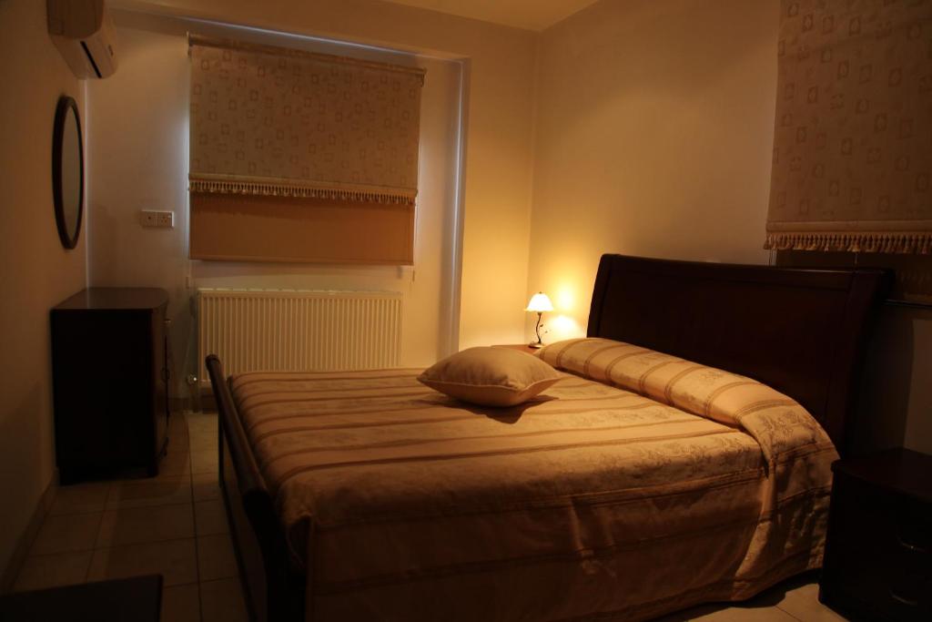 a bedroom with a bed with a pillow and a lamp at Vengera Suites in Galata