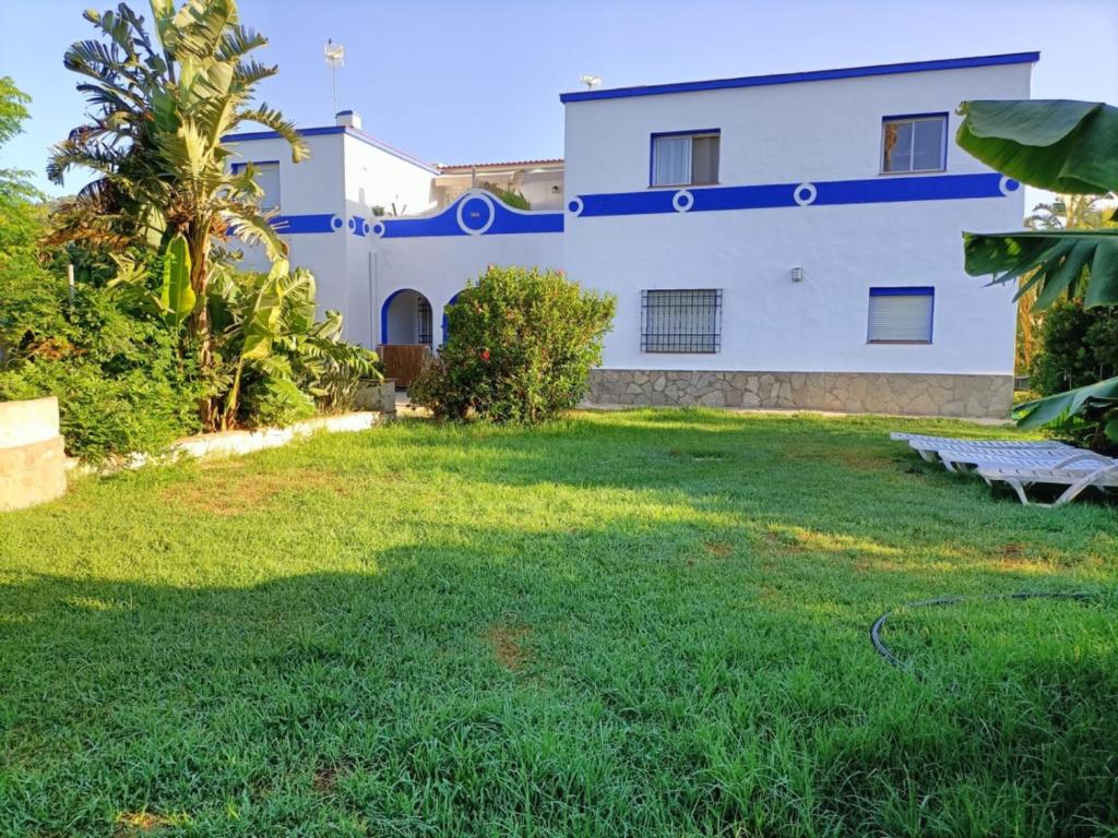 a house with a lawn in front of it at El Palomar Rooms Tarifa in Tarifa