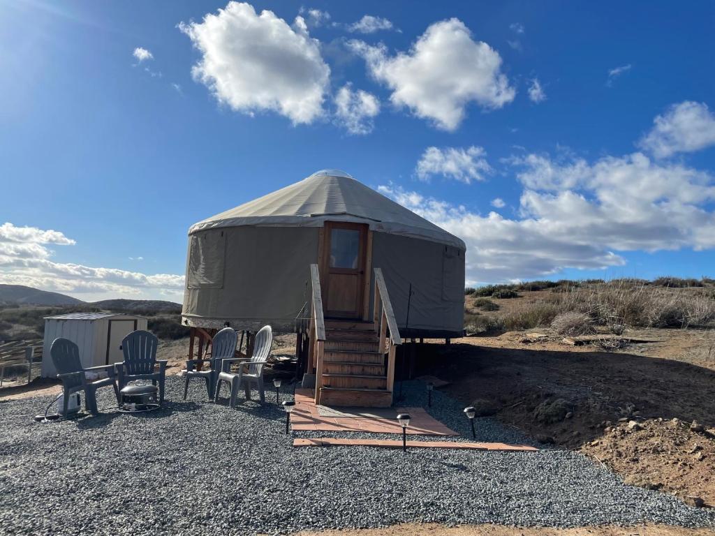 a yurt with a staircase and chairs in the desert at Yurt Escape with Amazing Country Views in Temecula