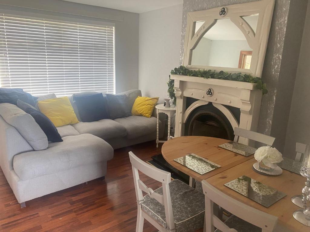 a living room with a couch and a table and a mirror at Timmy’s in Toome in Toome