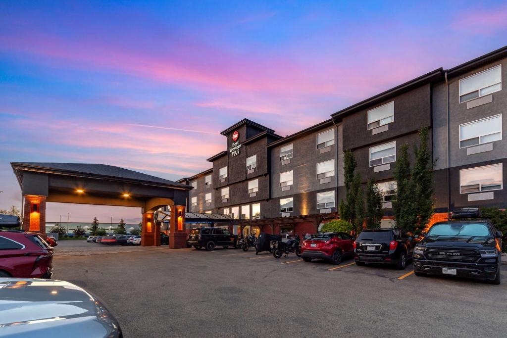 a hotel with cars parked in a parking lot at Best Western Plus West Edmonton in Edmonton