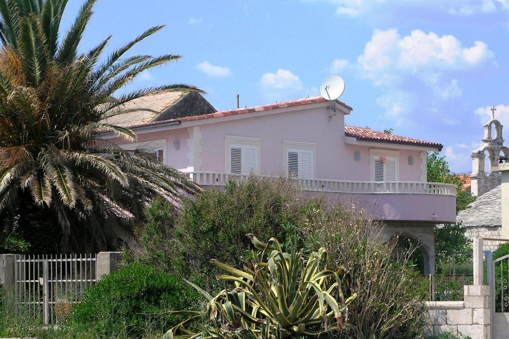 a pink house with a antenna on top of it at Apartments by the sea Sucuraj, Hvar - 5680 in Sućuraj