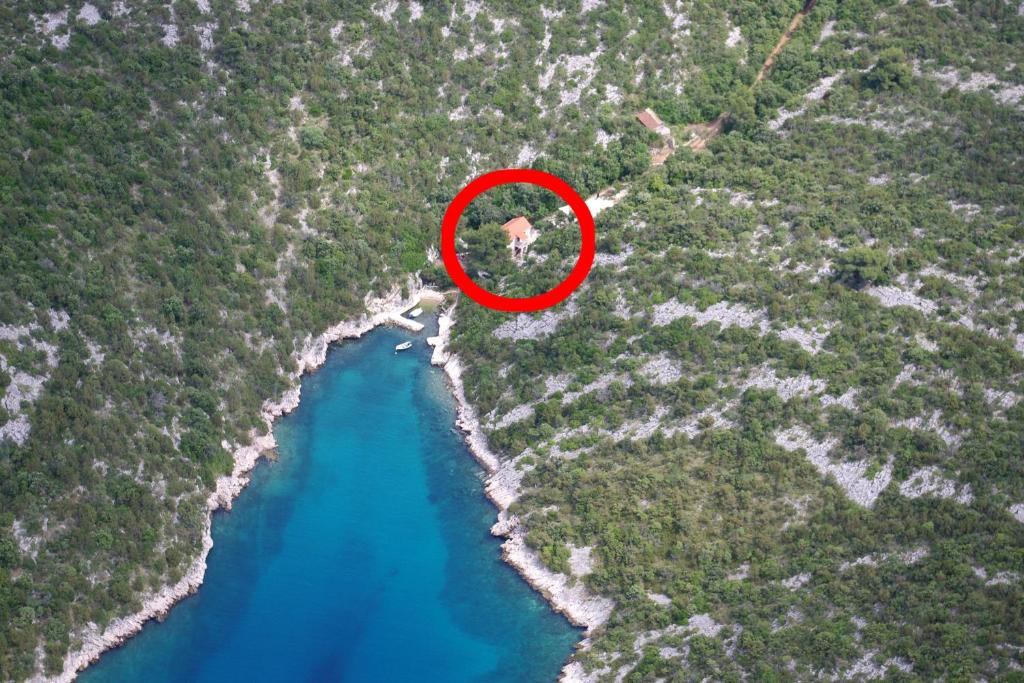 a red circle in the middle of a river at Seaside secluded apartments Cove Tatinja, Hvar - 5729 in Vrbanj