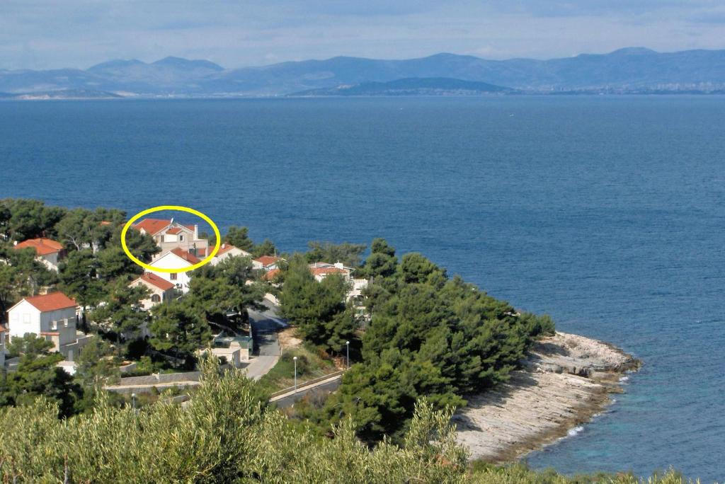 an island with a house in the middle of the water at Apartments by the sea Postira, Brac - 5672 in Postira