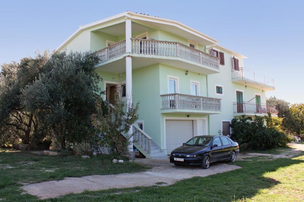 a house with a car parked in front of it at Apartments with a parking space Bibinje, Zadar - 5753 in Bibinje