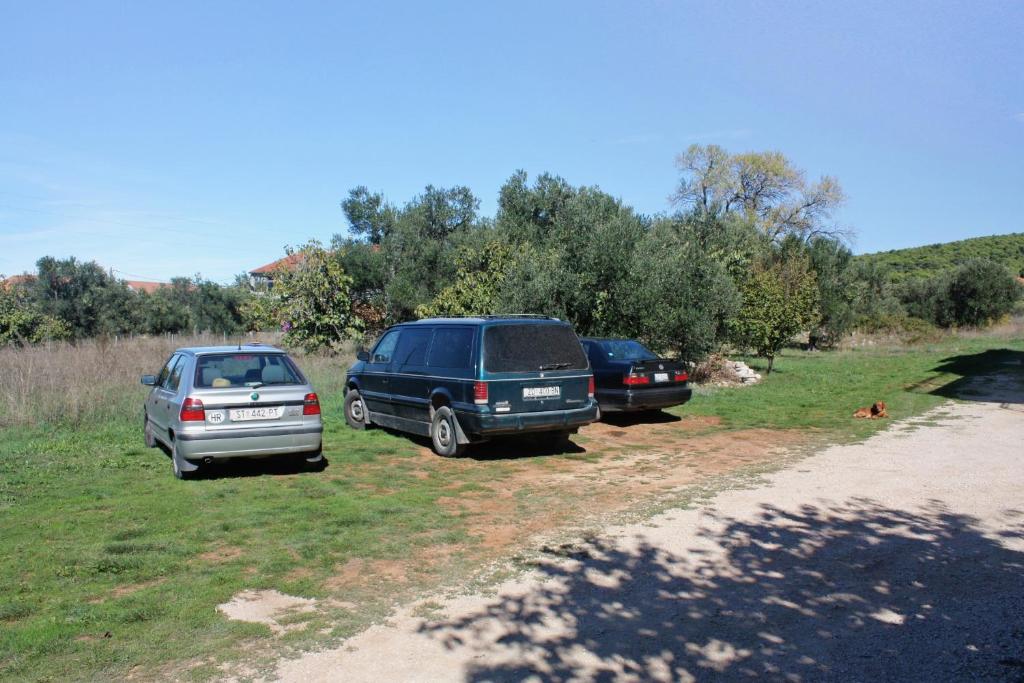 two cars parked on the side of a dirt road at Apartments with a parking space Bibinje, Zadar - 5753 in Bibinje