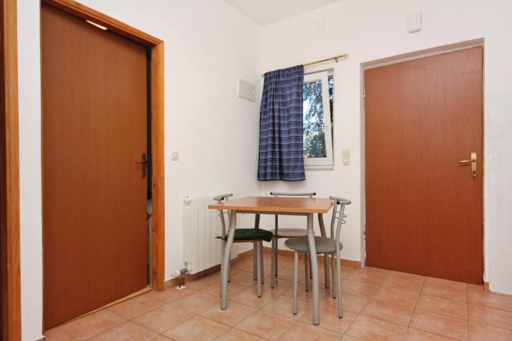 a table and chairs in a room with a door at Apartments with a parking space Bibinje, Zadar - 5753 in Bibinje