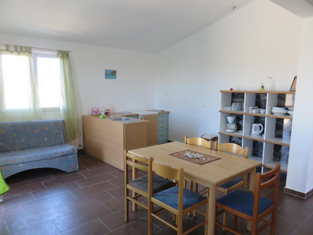 a kitchen and dining room with a table and chairs at Apartments with a parking space Bibinje, Zadar - 5753 in Bibinje