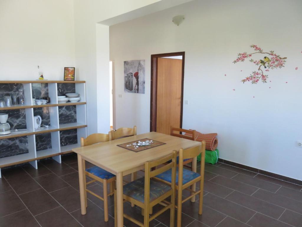 a dining room with a wooden table and chairs at Apartments with a parking space Bibinje, Zadar - 5753 in Bibinje