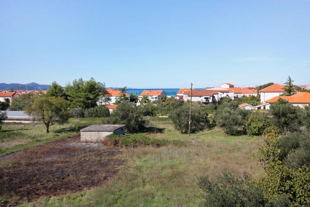 a view of a field with houses in the background at Apartments with a parking space Bibinje, Zadar - 5753 in Bibinje