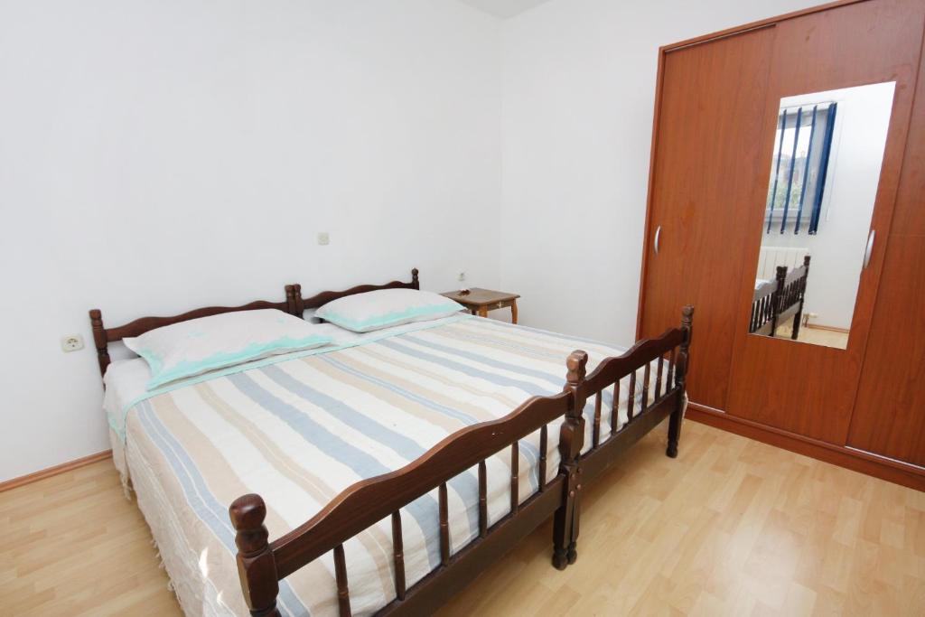 a bedroom with a bed and a mirror in it at Apartments with a parking space Bibinje, Zadar - 5753 in Bibinje