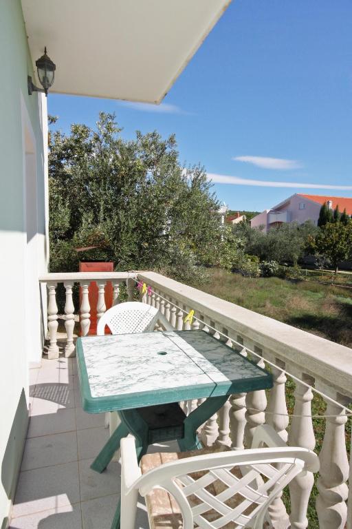 a table and chairs on the balcony of a house at Apartments with a parking space Bibinje, Zadar - 5753 in Bibinje