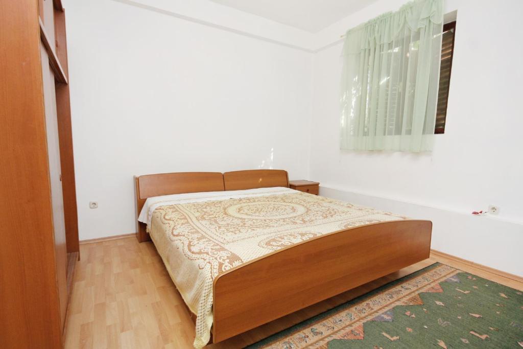 a bedroom with a bed in a white room at Apartments with a parking space Bibinje, Zadar - 5753 in Bibinje