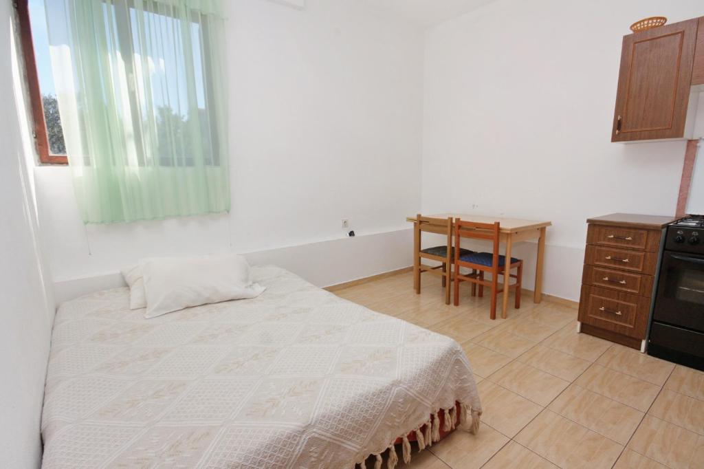 a bedroom with a bed and a table and a desk at Apartments with a parking space Bibinje, Zadar - 5753 in Bibinje